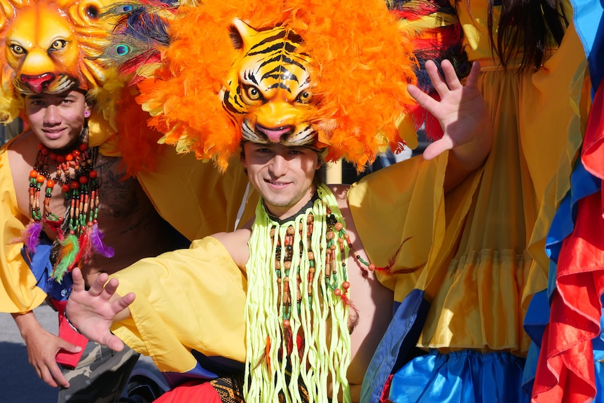 A man wearing a tiger headdress and yellow robe