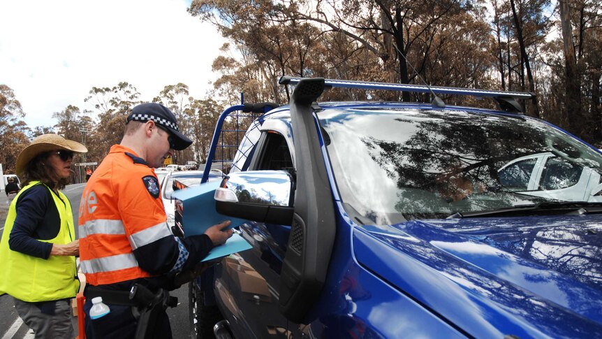 A car is checked at the police checkpoint on Tasmania's Arthur Highway.