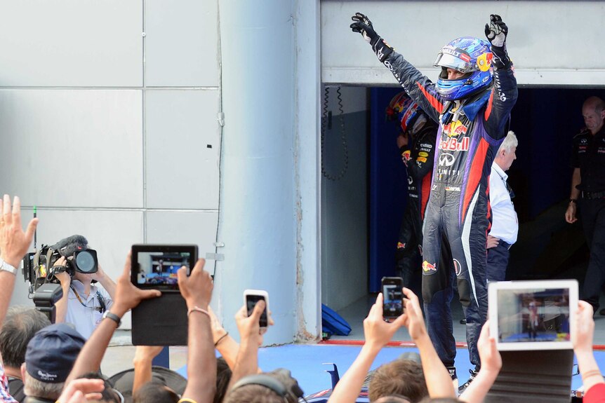 Apologetic winner ... Sebastian Vettel celebrates in Malaysia.