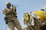 Radiation expert examines uranium mixing vat in Iraq