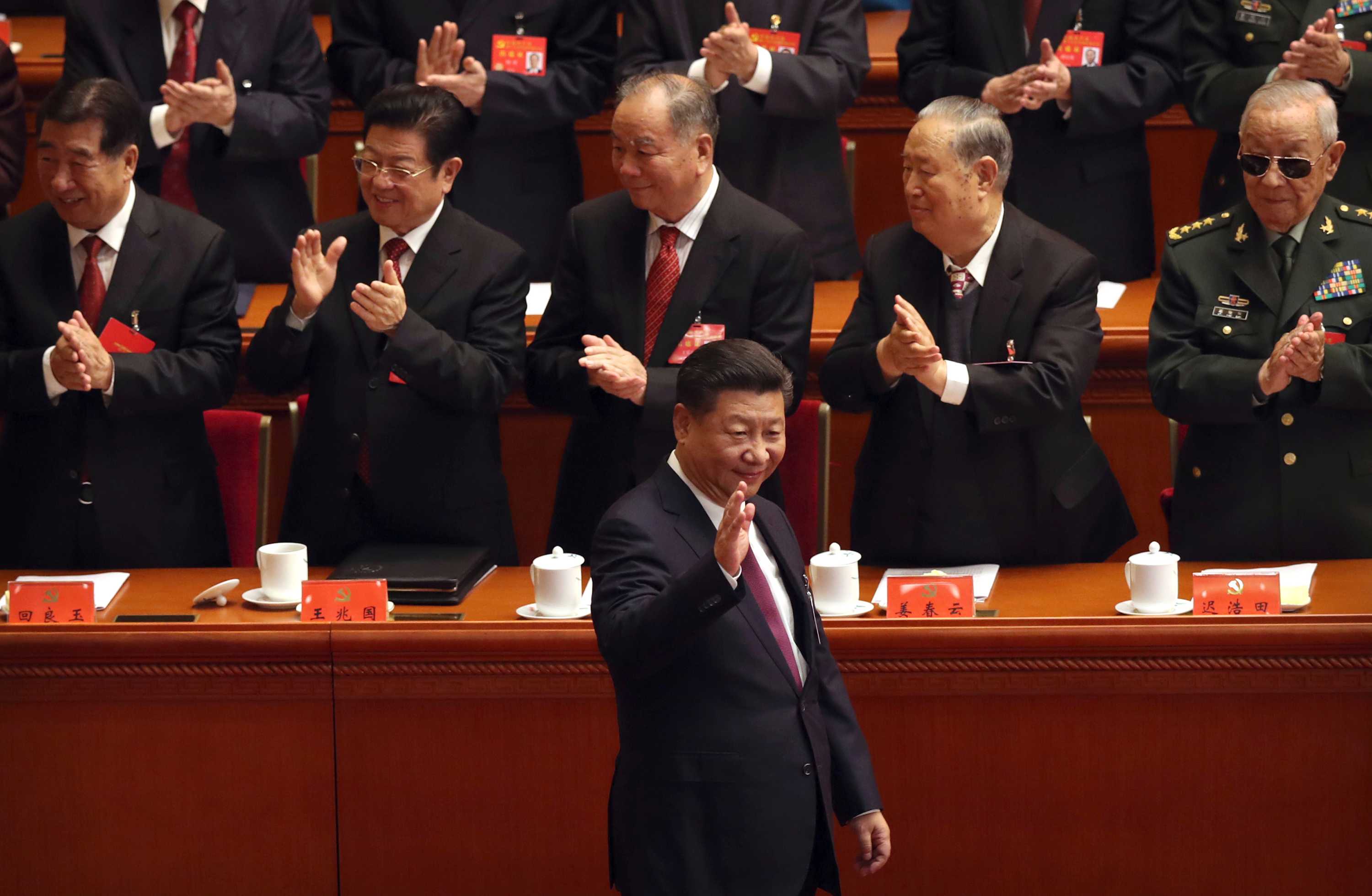 Chinese President Xi Jinping waves as he is clapped by his supporters at China's 19th Party Congress.