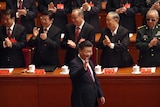 Chinese President Xi Jinping waves as he is clapped by his supporters at China's 19th Party Congress.