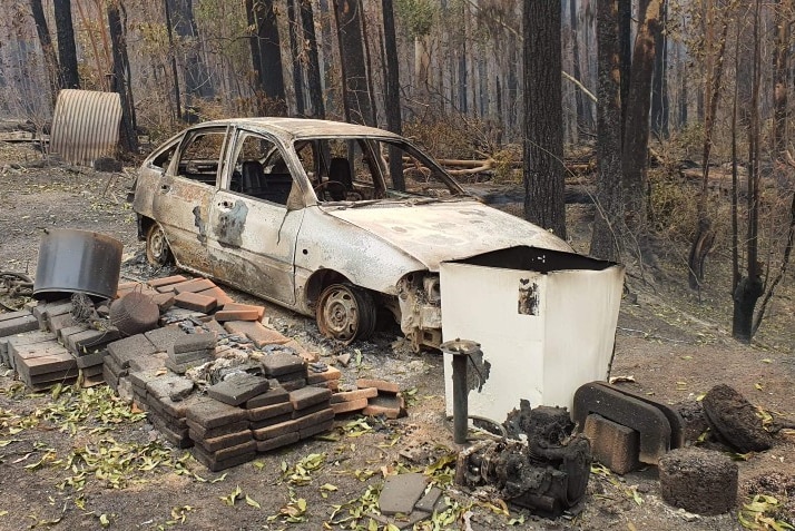 Charred bricks and a burnt out car after bushfires