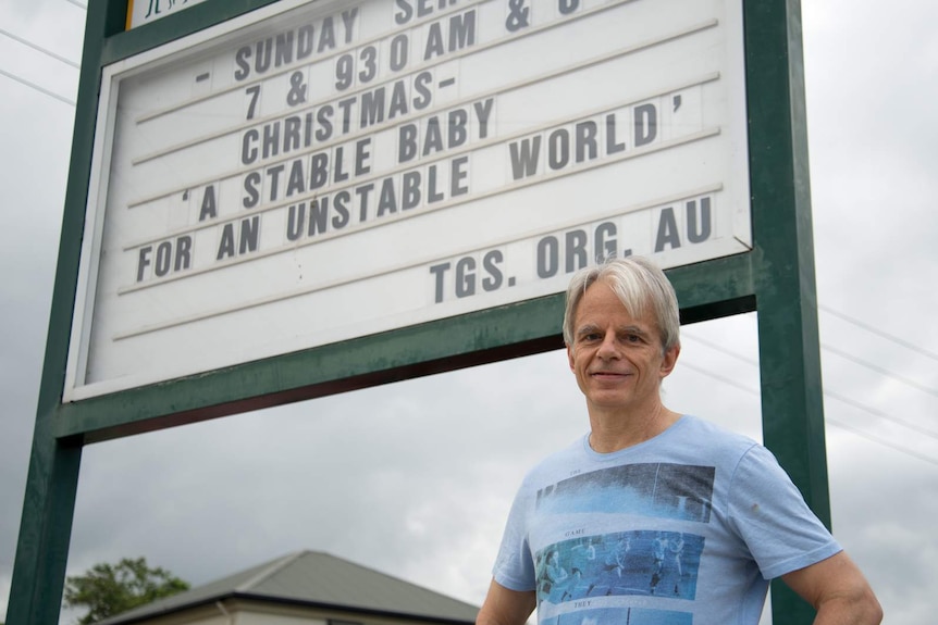 James Sartain stands proudly in front of his most recent sign that reads: 'Christmas - a stable baby for an unstable world'.