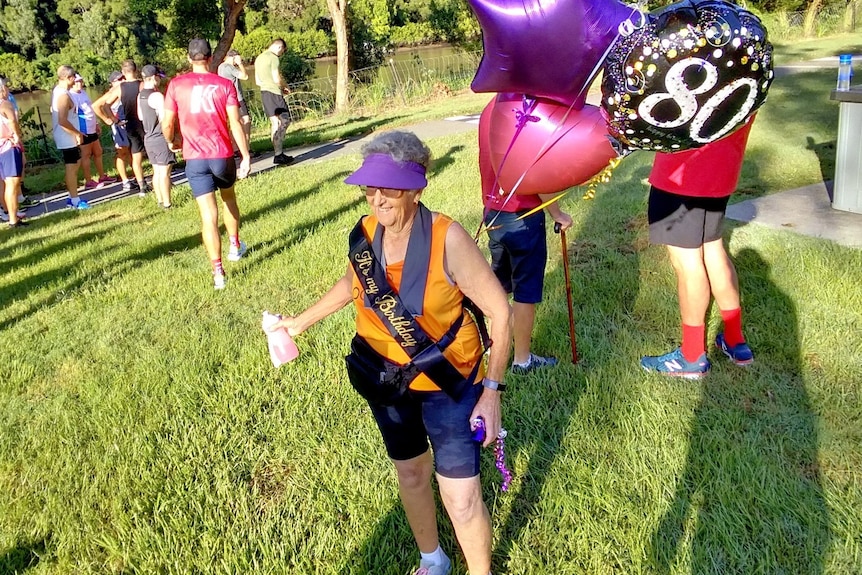 Lenore Rutley with 80th-birthday balloons.