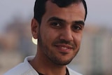Close-up of Yasser Murtaja wearing a press jacket.