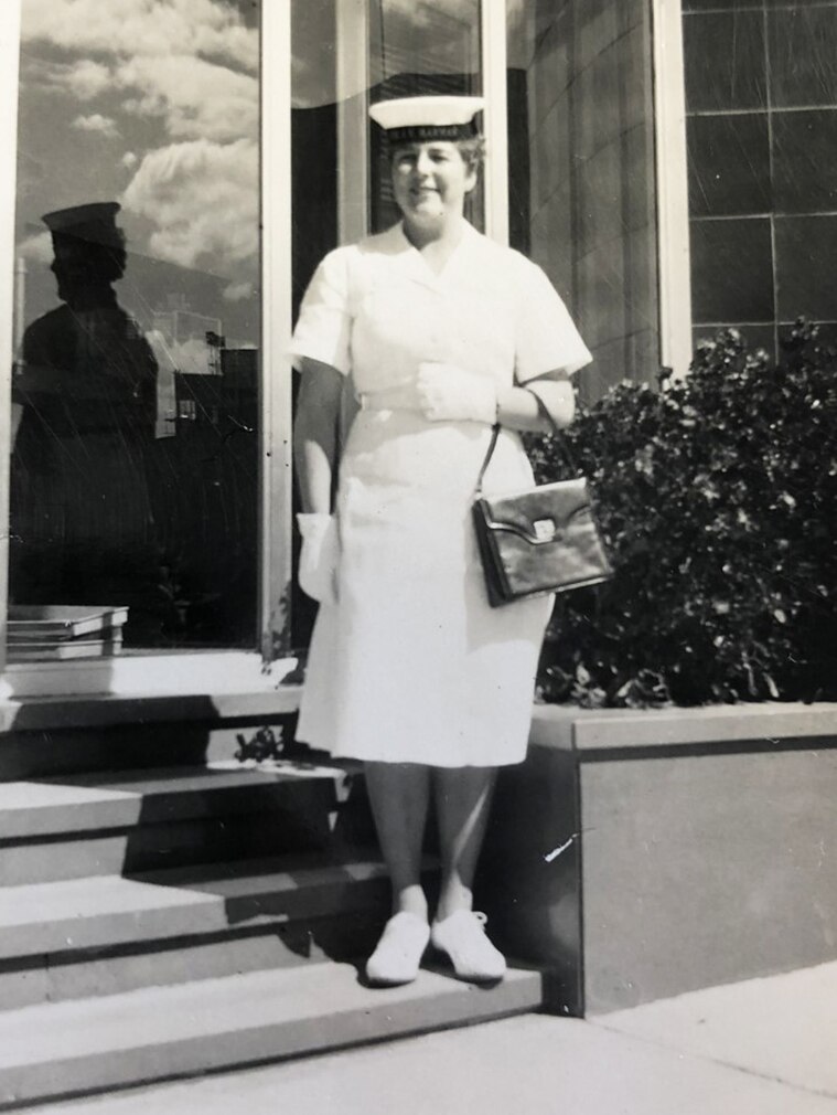 Dawn Fletcher in the WRAN in 1958. She wears a navy uniform with hat, and carries a neat handbag.