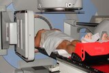 A man undergoes radiation treatment.