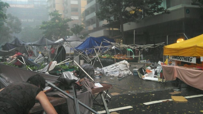 Market stalls at Kelvin Grove in Brisbane are washed away as a severe storm sweeps through the city, November 17, 2012.