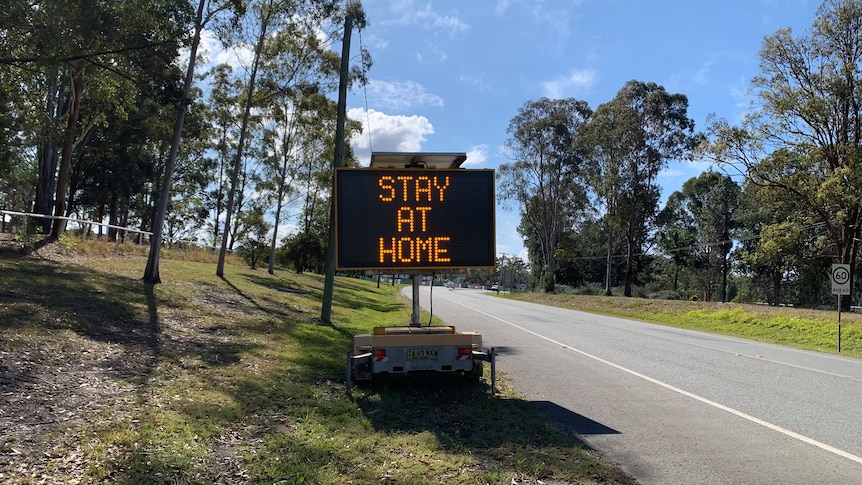 An electronic road sign with the words "stay at home".