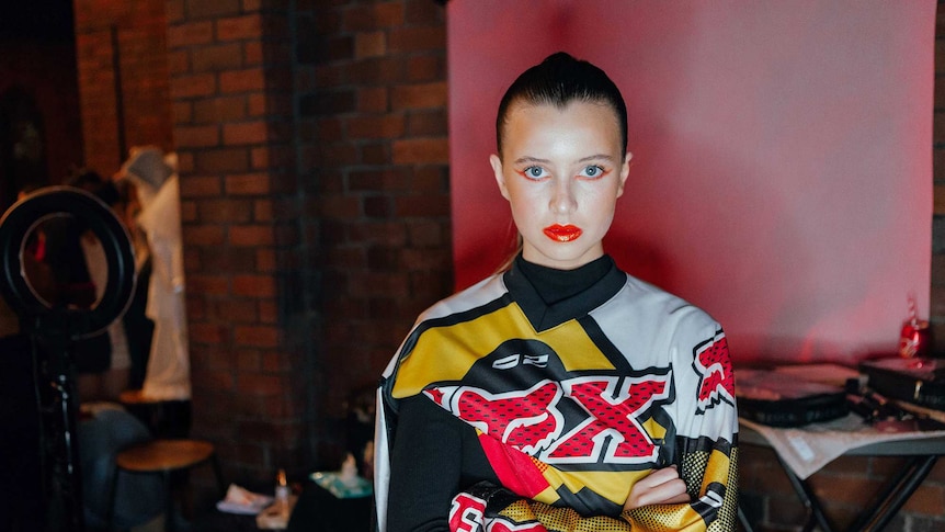 A fashion model poses in a recycled outfit sourced from recycled clothes