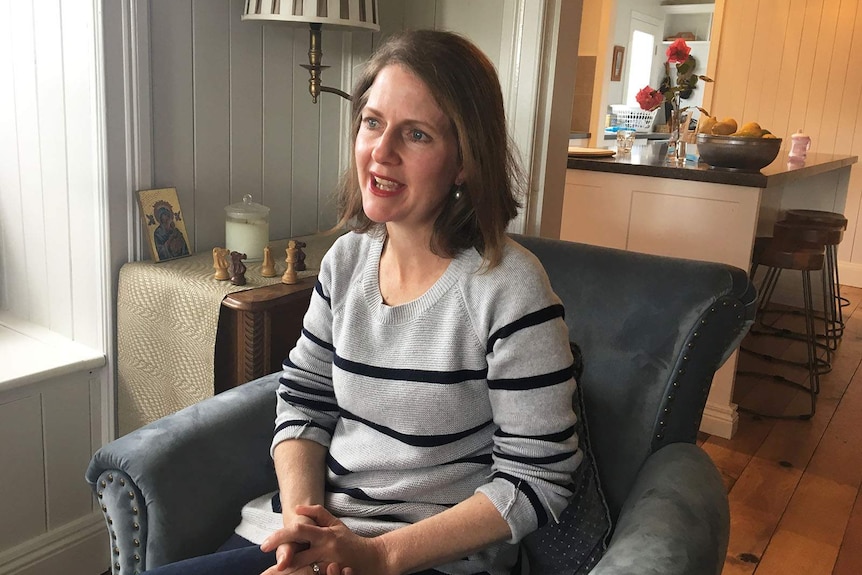 Angela Duff sits on a chair in her Toowoomba home.