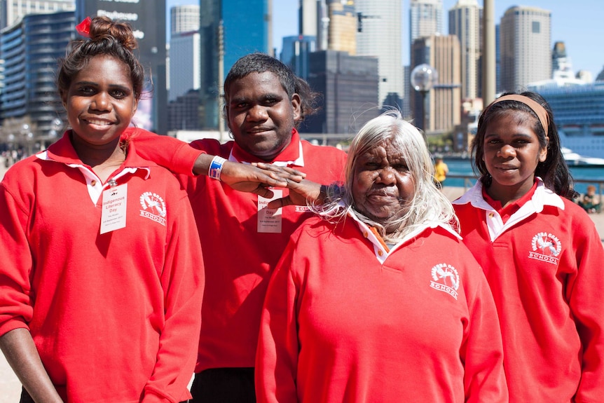 Elder Mary Vanbee and Yakanarra students Zarlia Vanbee, Keenan Vanbee, Ella Jubadah stand in Circular Quay