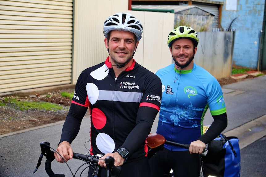 Lloyd Collier and Louis Snellgrove pose on their tandem bike in a laneway