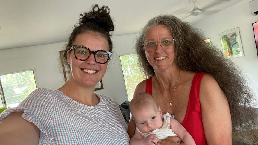 Molly and her mother Wendy Baxter who is holding a baby.