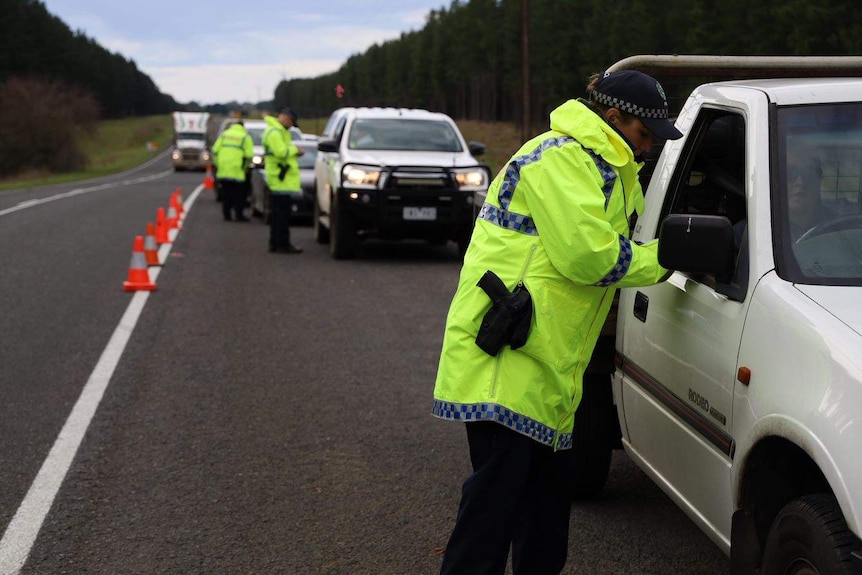 Police patrol a border checkpoint in South Australia