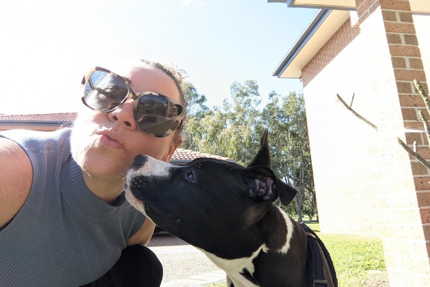 Kirsty Waye kisses her five-month old puppy Lola.