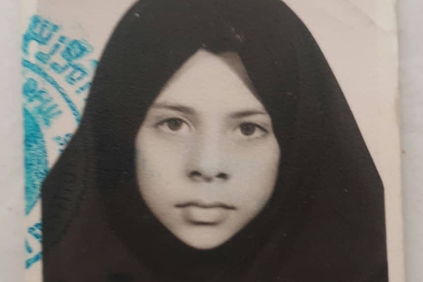 A girl in an Islamic headscarf with an official stamp
