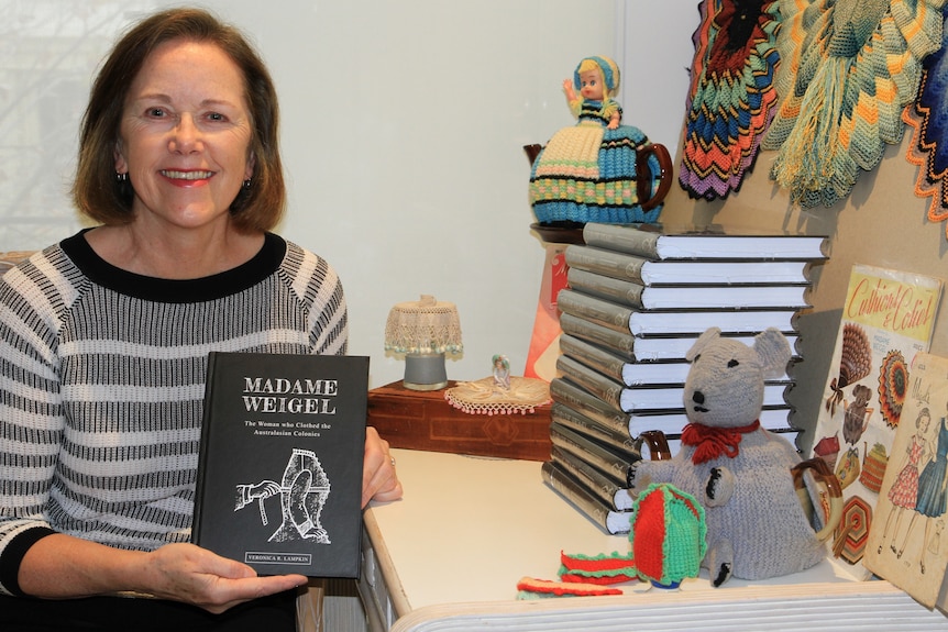 Photo of Veronica Lampkin holding her book 'Madame Weigel'.