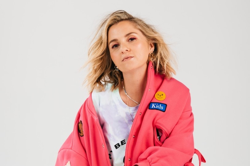 A blonde woman in a pink jacket