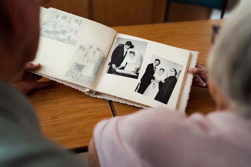 Kay and Bob Lockley look at their wedding album