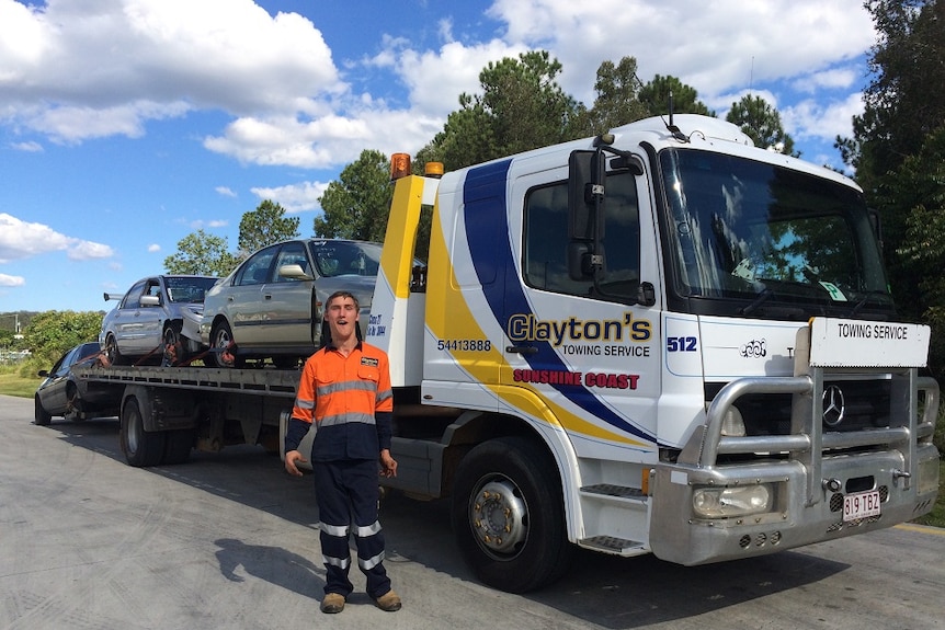 A man standing in front of a truck.