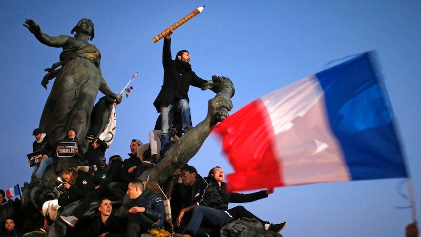 Man holds giant pencil in solidarity march for Charlie Hebdo victims