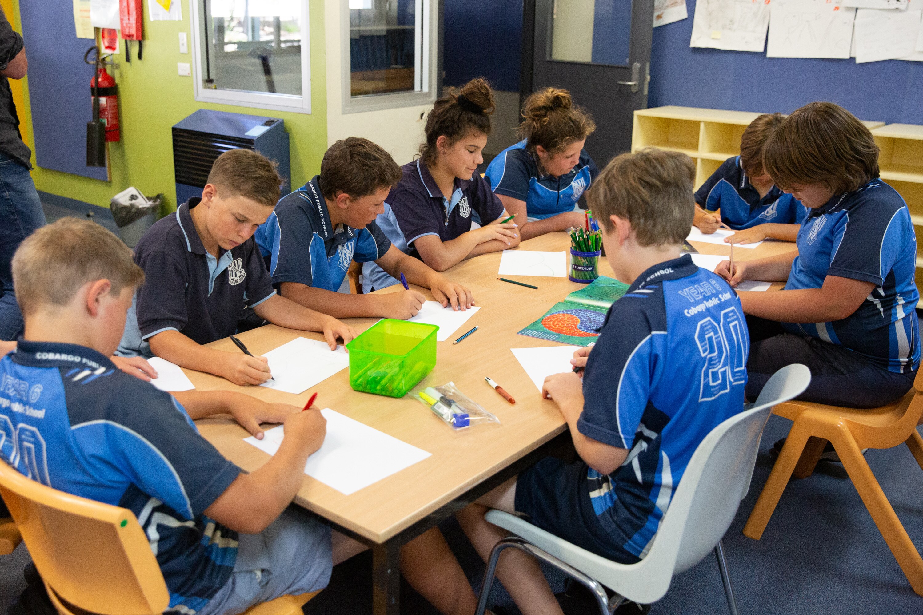 Students at a primary school working at a table.