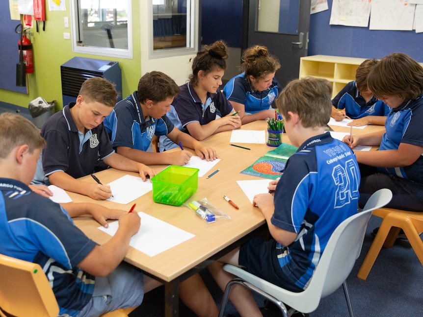 Students at a primary school working at a table.