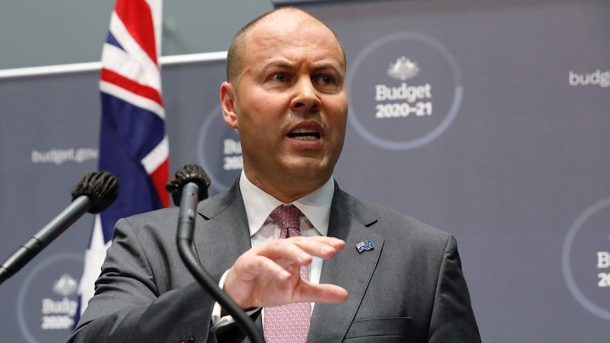 Josh Frydenberg speaks at a podium.