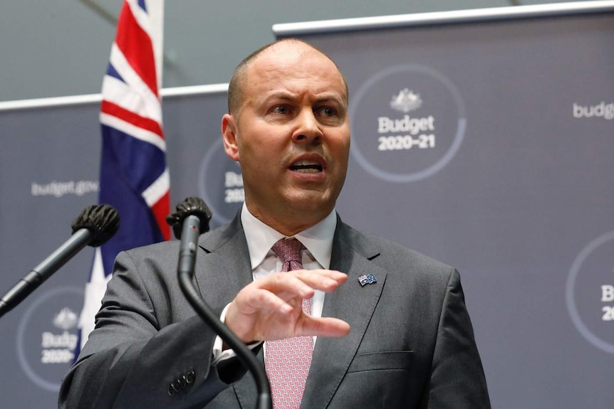 Josh Frydenberg speaks at a podium.