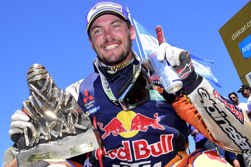 Toby Price celebrates with the Dakar Rally trophy