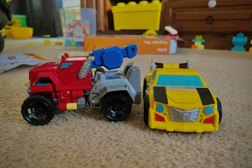 Red and yellow transformers toys on carpet