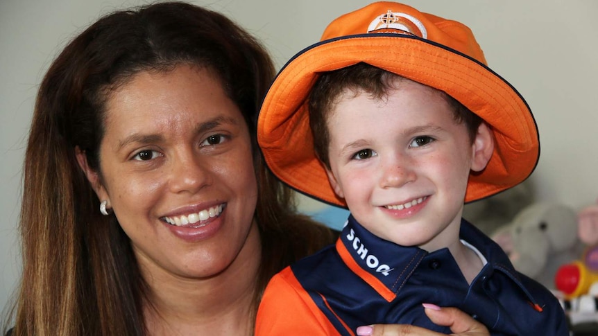 Brenda Lopez-Carroll with her four-year-old son Cristiano, dressed in his school uniform.