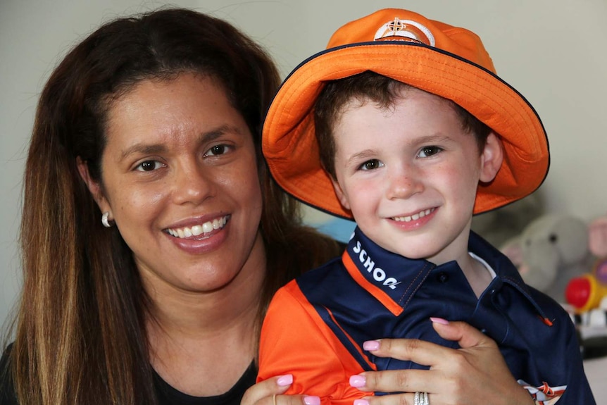 Brenda Lopez-Carroll with her four-year-old son Cristiano, dressed in his school uniform.