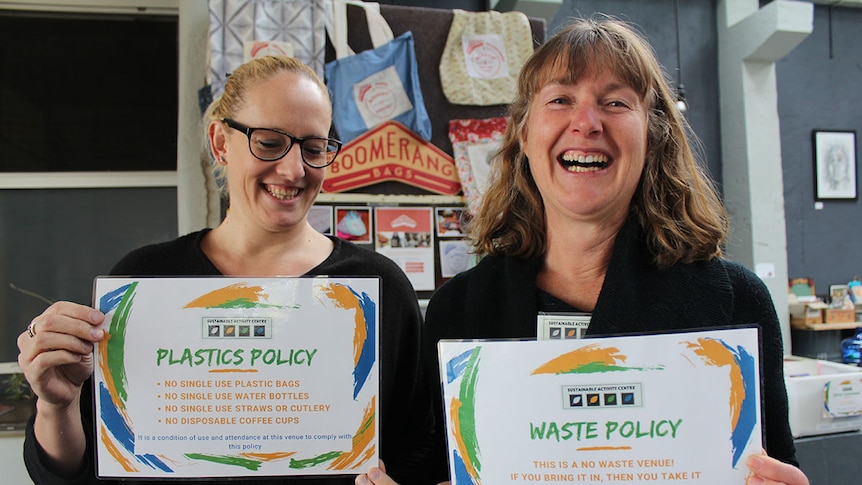 Claire Greenhalgh and Sharon Potocnik hold the Sustainable Activity Centre's no waste policy signs.