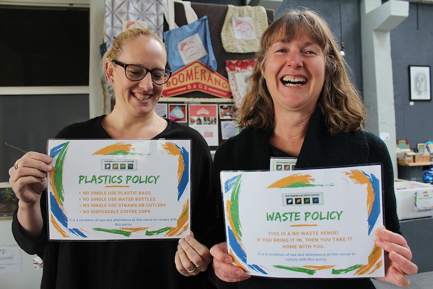 Claire Greenhalgh and Sharon Potocnik hold the Sustainable Activity Centre's no waste policy signs.