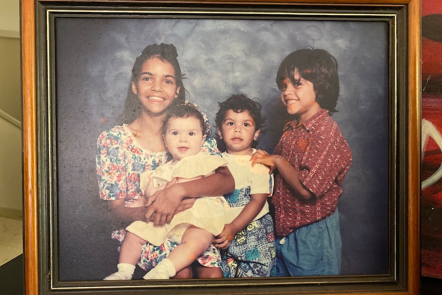 A framed photo of 4 children