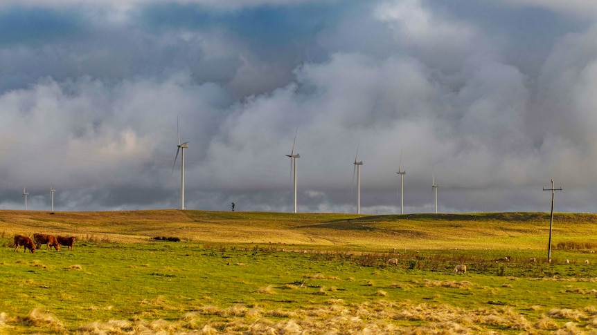 drak grey skies over a field with wind farms in taralga north of goulburn new south wales