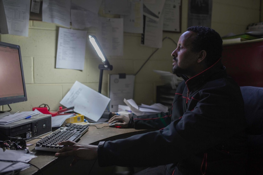 Hamdi Ali sits at his computer