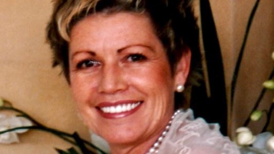 An image of a woman with short hair, smiling