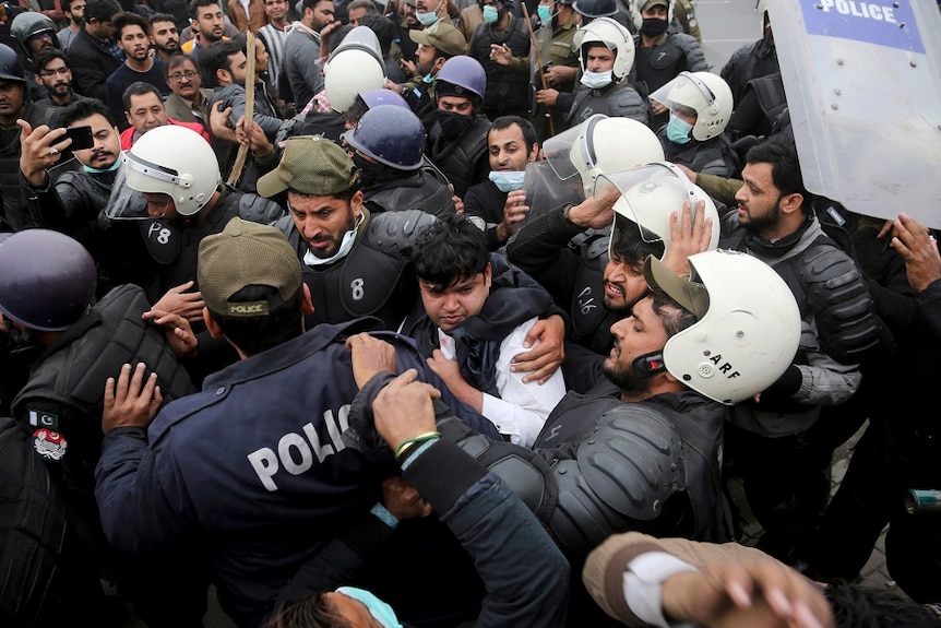 Police officers scuffle with angry lawyers during a clash in Lahore, Pakistan.