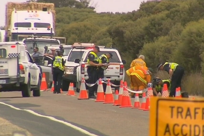 Emergency service staff and vehicles on the road where a cyclist was hit by a car.