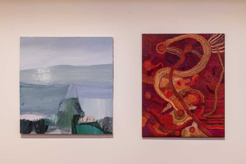 Two finalists in the Hadley's Art Prize hang on a wall.