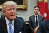 Jared Kushner sits behind his father-in-law Donald Trump, who is out of focus.