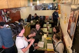 A cafe with a table of people.