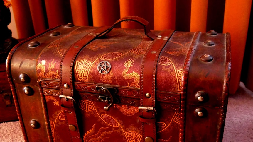 A leather trunk or spell box covered with pagan symbols.