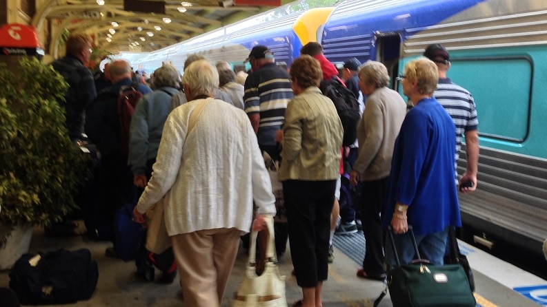 Passengers from the New England North West pouring off the CountryLink XPLORER at Muswellbrook to board buses to Sydney after rail lines were flooded in the Lower Hunter.  November 18, 2013.