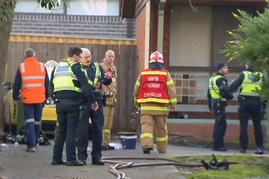 Police and firefighters outside a house in Heidelberg Heights.