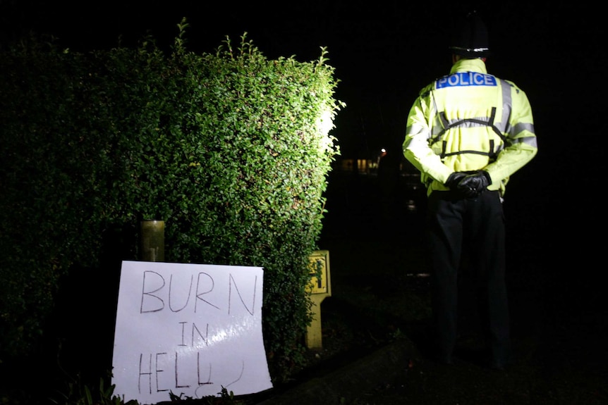 A sign reading Burn in Hell, left by an unidentified woman outside the 2002 funeral service of Myra Hindley.